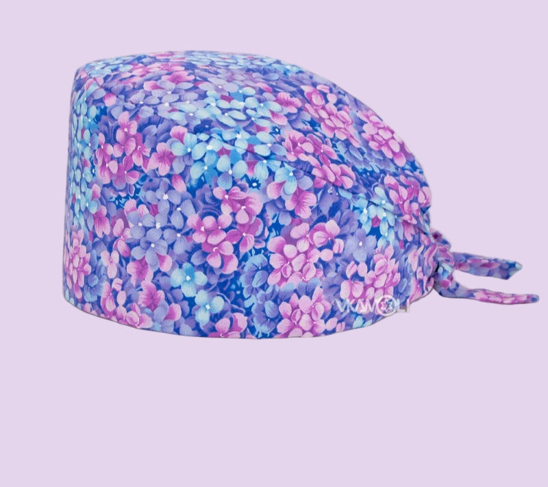 Check out these the Flower-Printed OR Caps! You know, because nothing says 'I'm a professional' like wearing a cap that looks like a garden party exploded on your head - Healthcare Vibes