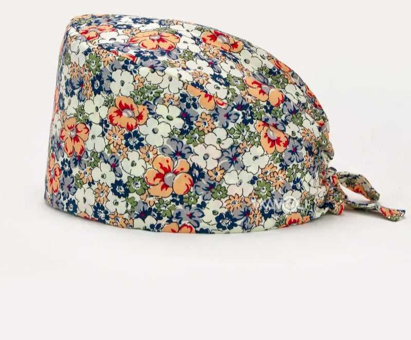 Check out these the Flower-Printed OR Caps! You know, because nothing says 'I'm a professional' like wearing a cap that looks like a garden party exploded on your head - Healthcare Vibes