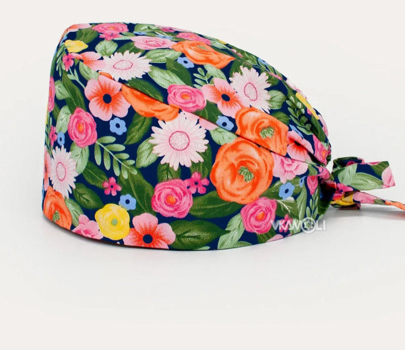 Check out these the Flower-Printed OR Caps! You know, because nothing says 'I'm a professional' like wearing a cap that looks like a garden party exploded on your head - Healthcare Vibes