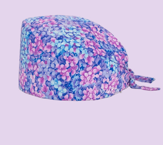 Check out these the Flower-Printed OR Caps! You know, because nothing says 'I'm a professional' like wearing a cap that looks like a garden party exploded on your head - Healthcare Vibes